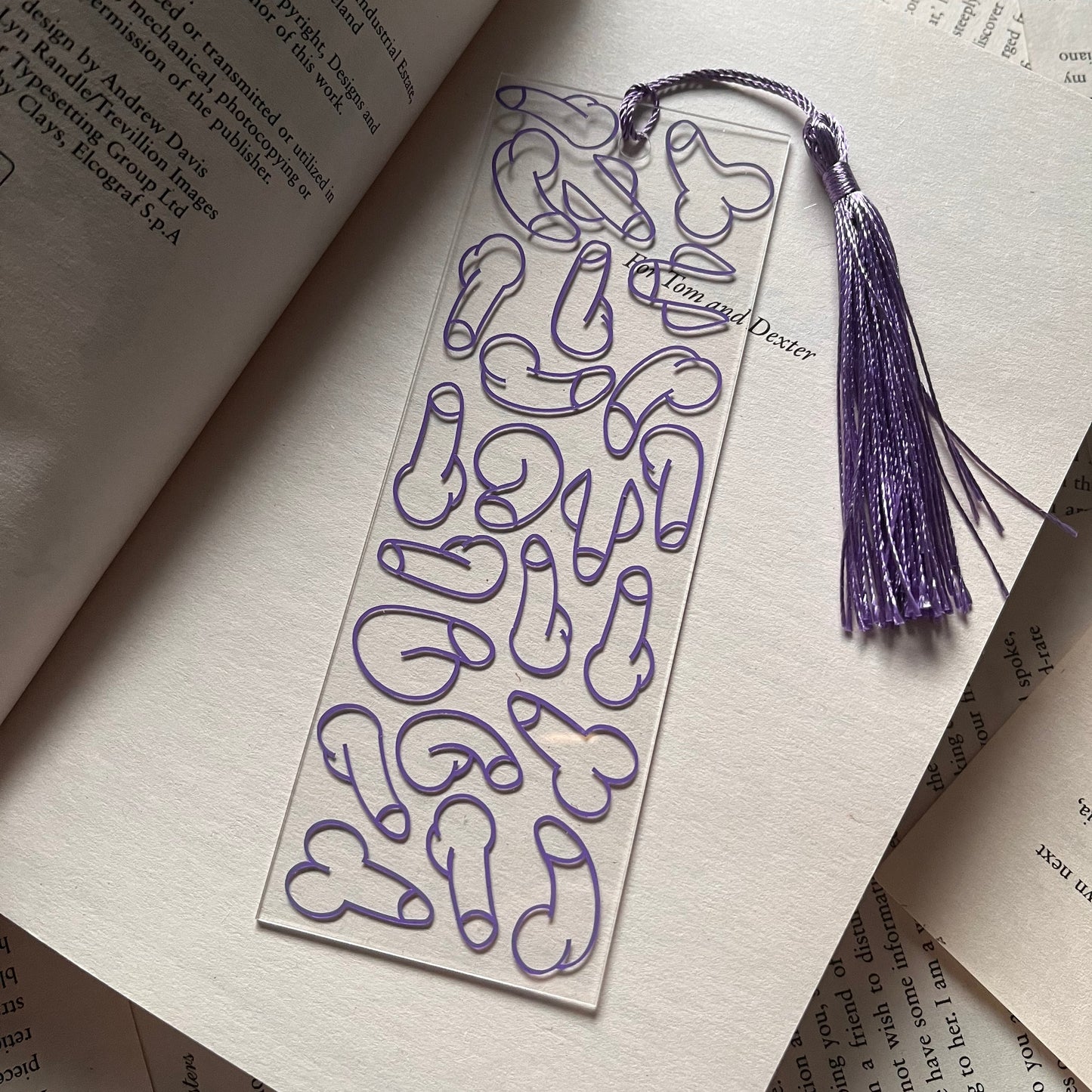 Bookmark with purple tassel on an open book