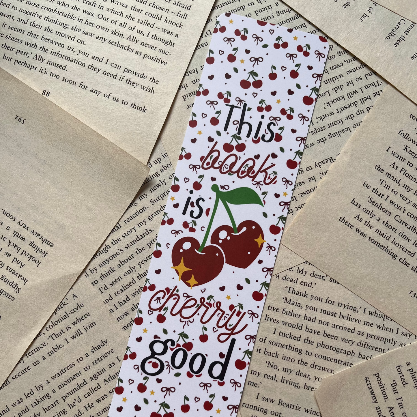 Bookmark with cherry design and text 'This book is cherry good' on a textured paper background