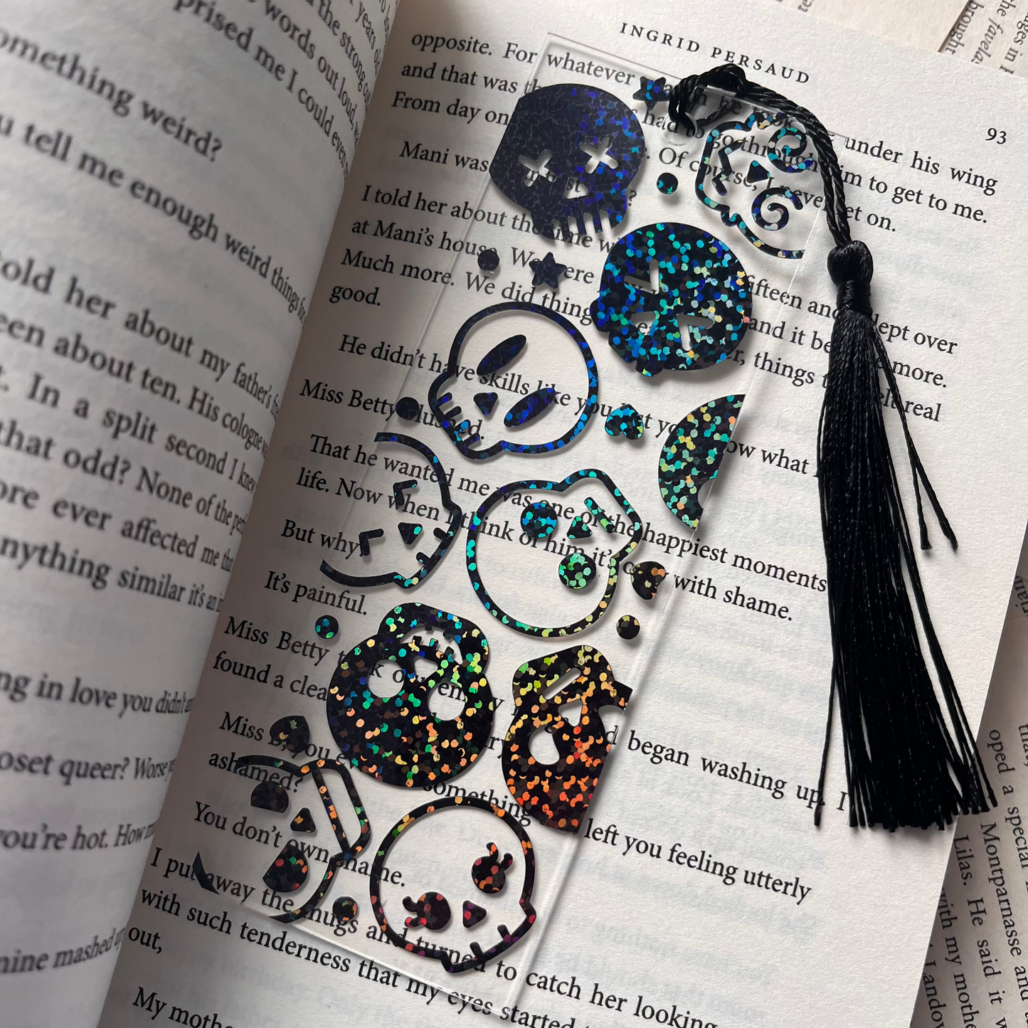 Decorative bookmark with a skull design with tassels on an open book