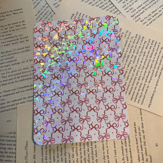 Holographic kindle insert with a cute bow pattern on decorative book pages