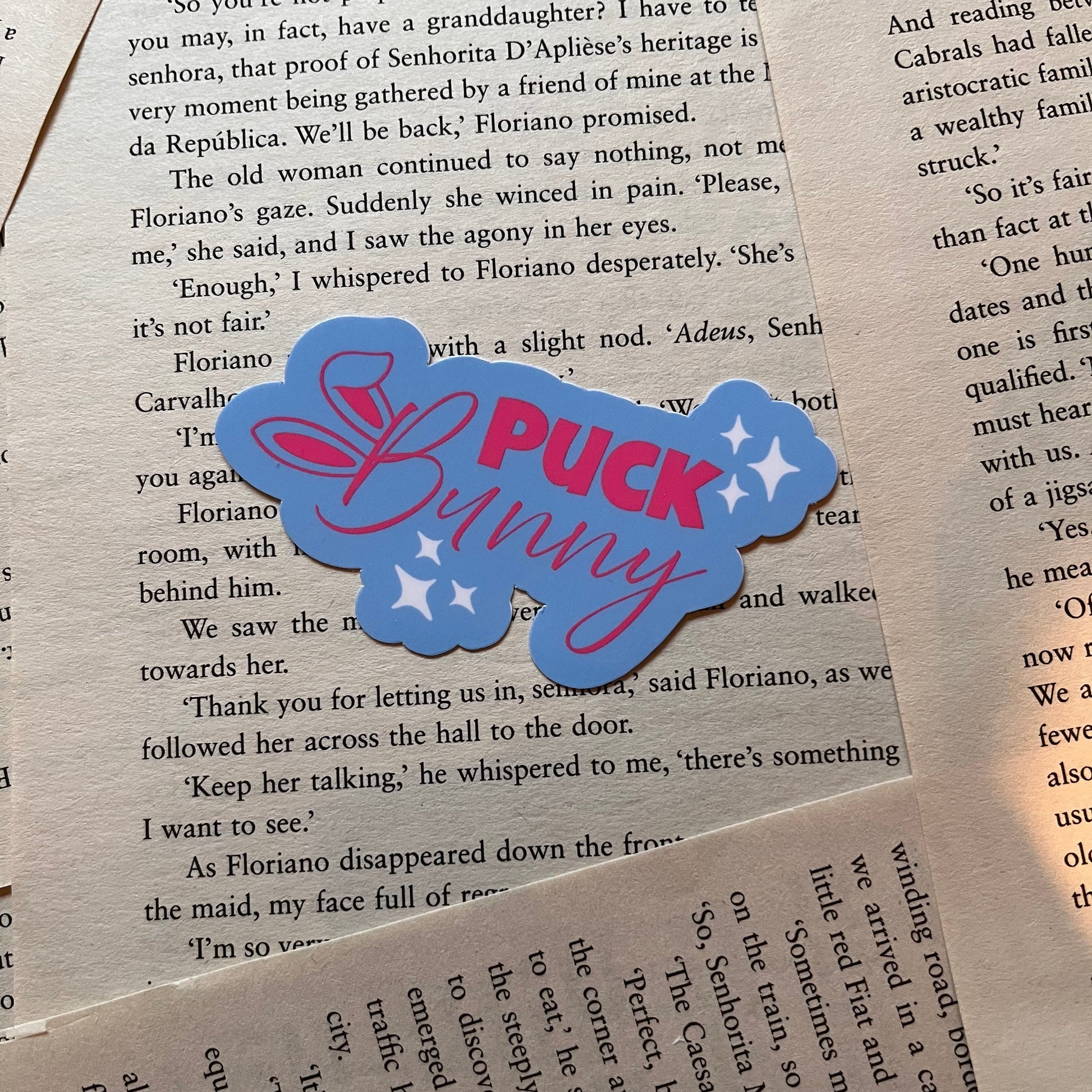 Blue and pink 'Puck Bunny' sticker on a book page