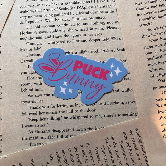 Blue and pink 'Puck Bunny' sticker on a book page