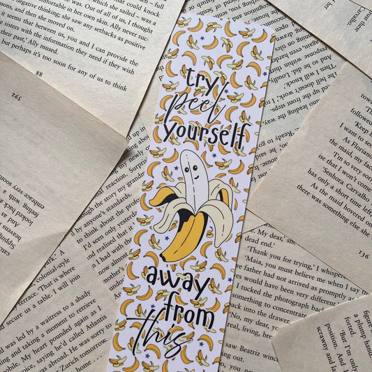 Bookmark with banana design and text on a textured paper background. Bookmark reads " Try peel yourself away from this"