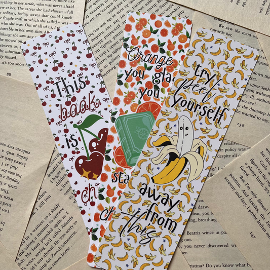 Three decorative bookmarks on a textured paper background