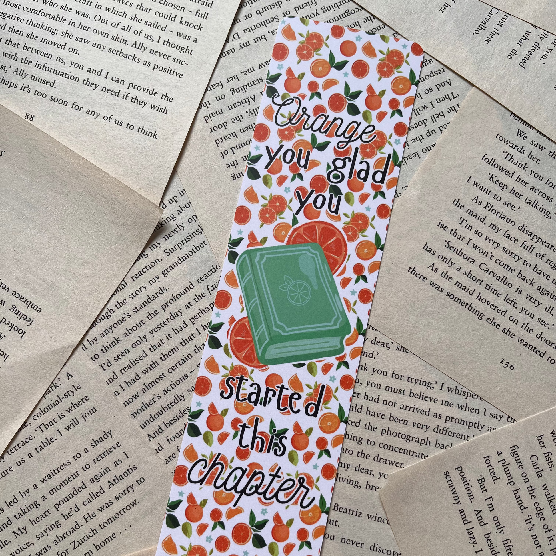 Bookmark with orange design and text on a textured paper background