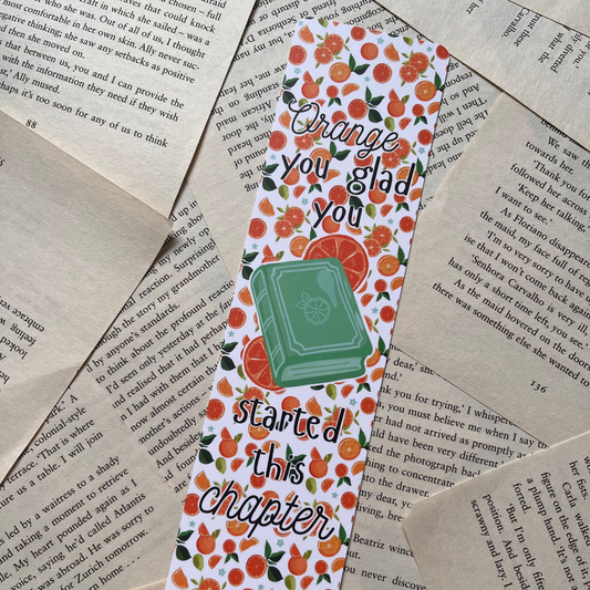 Bookmark with orange design and text on a textured paper background