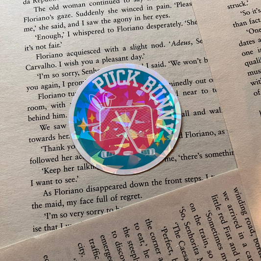 Colorful circular sticker with text " PUCK BUNNY" on a piece of paper with printed text