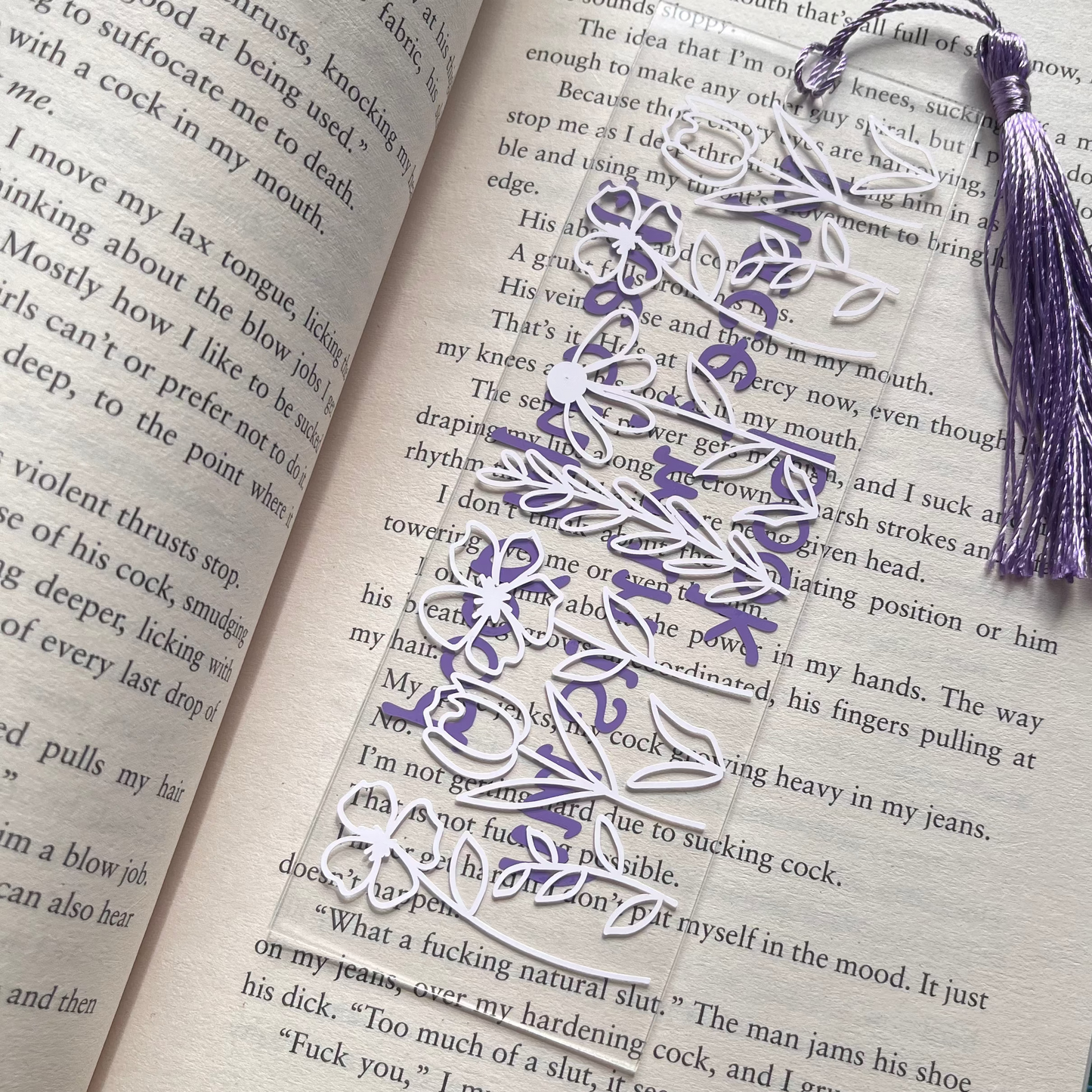 acrylic bookmark on an open book. Back showing a floral decal