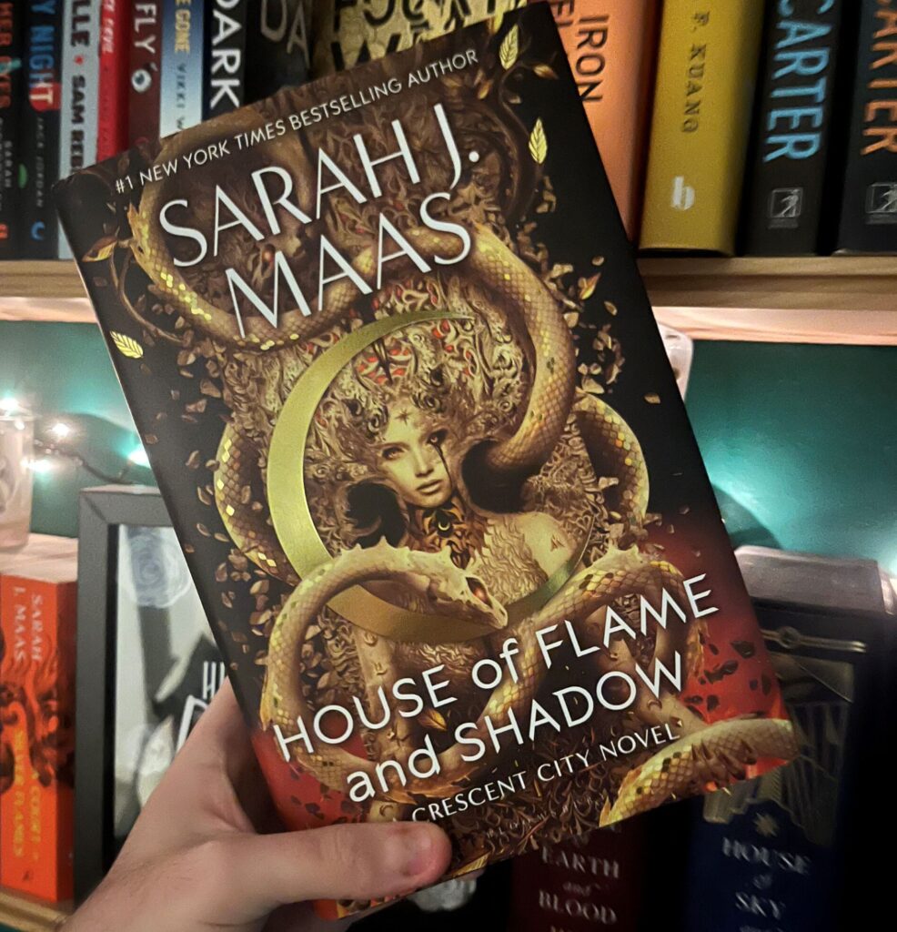 image show a hardback copy of House Of Flame And Shadow by Sarah J Maas